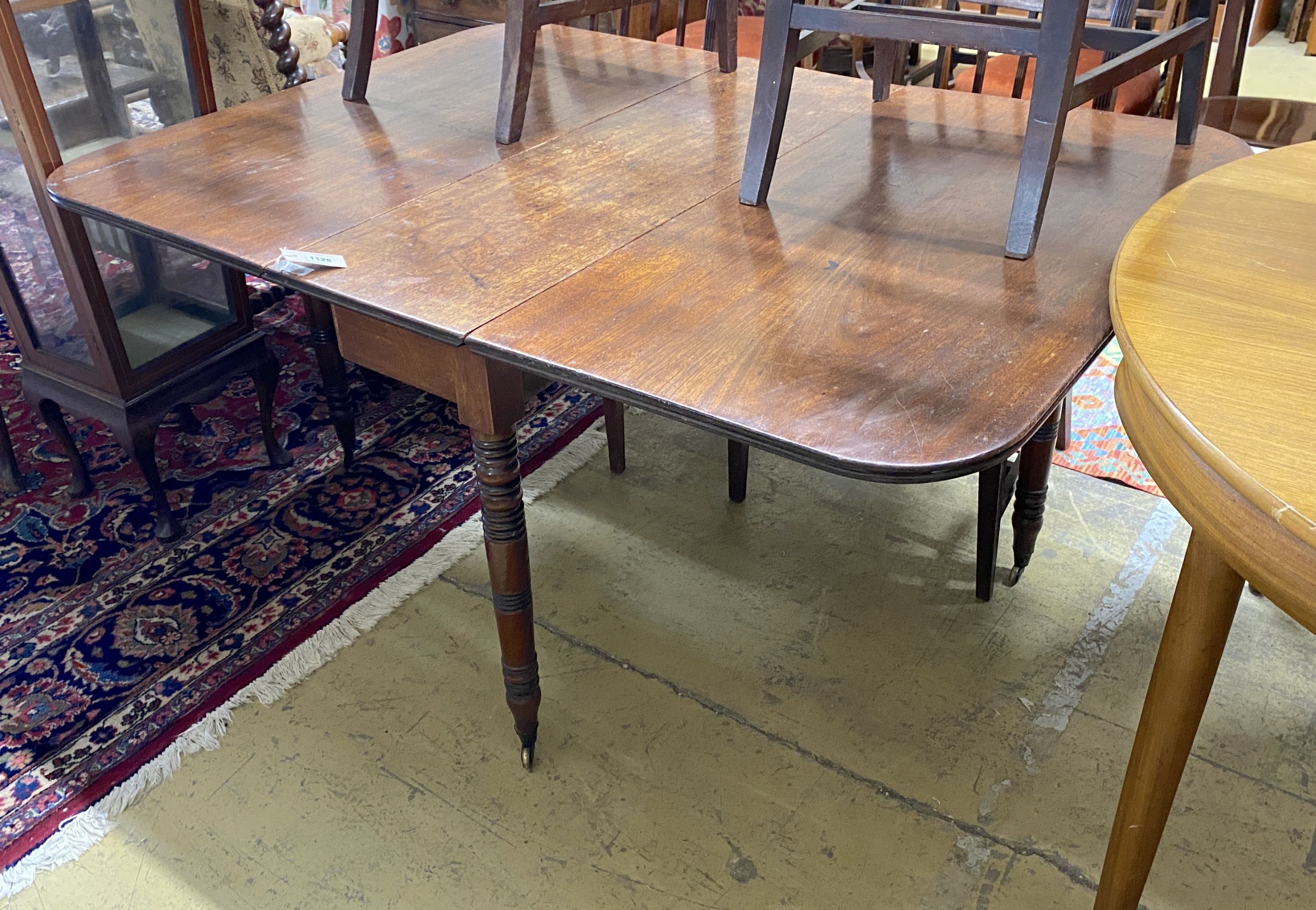 A Regency mahogany drop leaf dining table, 146cm extended, depth 106cm, height 70cm and six Regency provincial mahogany dining chairs, one with arms